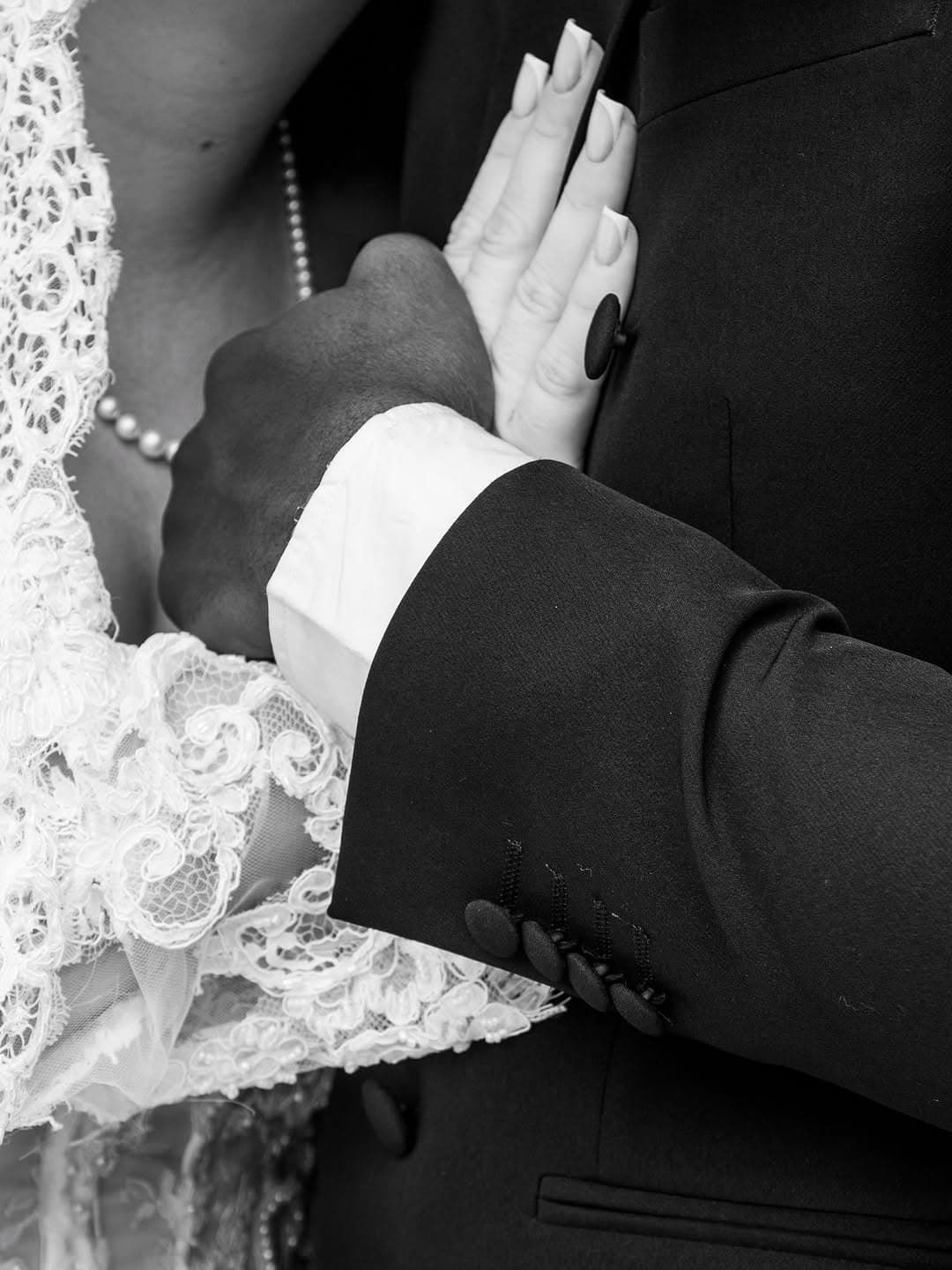 Les mains des mariés, détail en noir et blanc